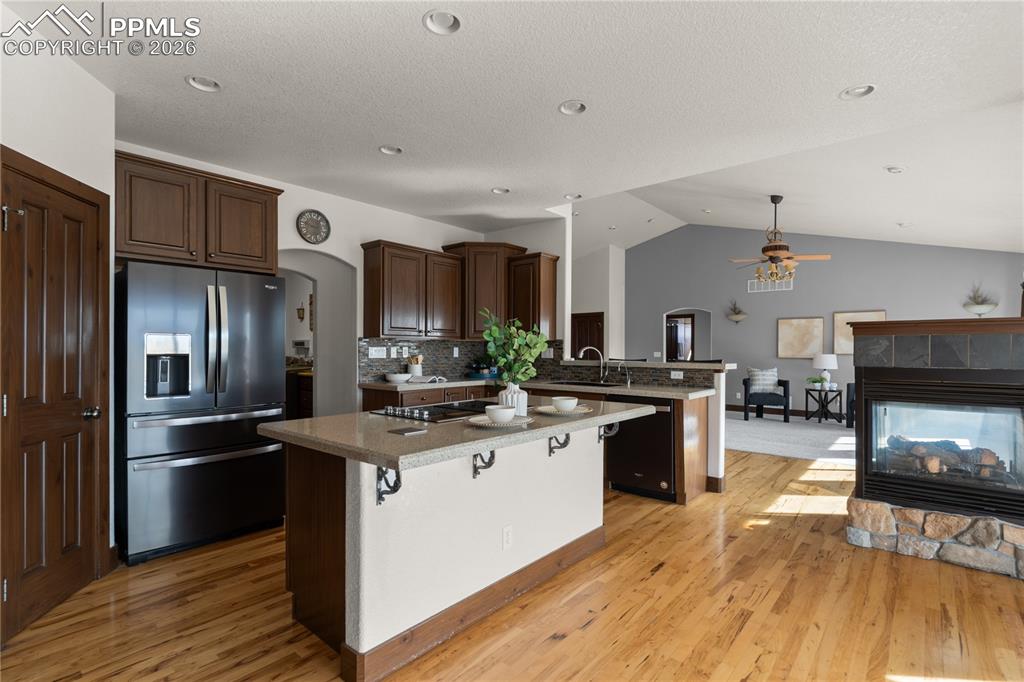 Chef’s kitchen with stainless steel appliances, solid surface countertops, and instant hot water