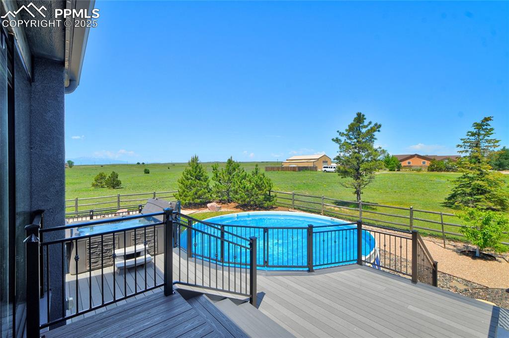 A generous composite deck with railings, a above ground pool and hot tub... what more could you need?