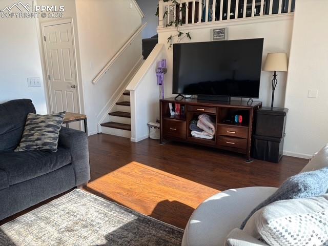 Living room featuring dark wood-type flooring