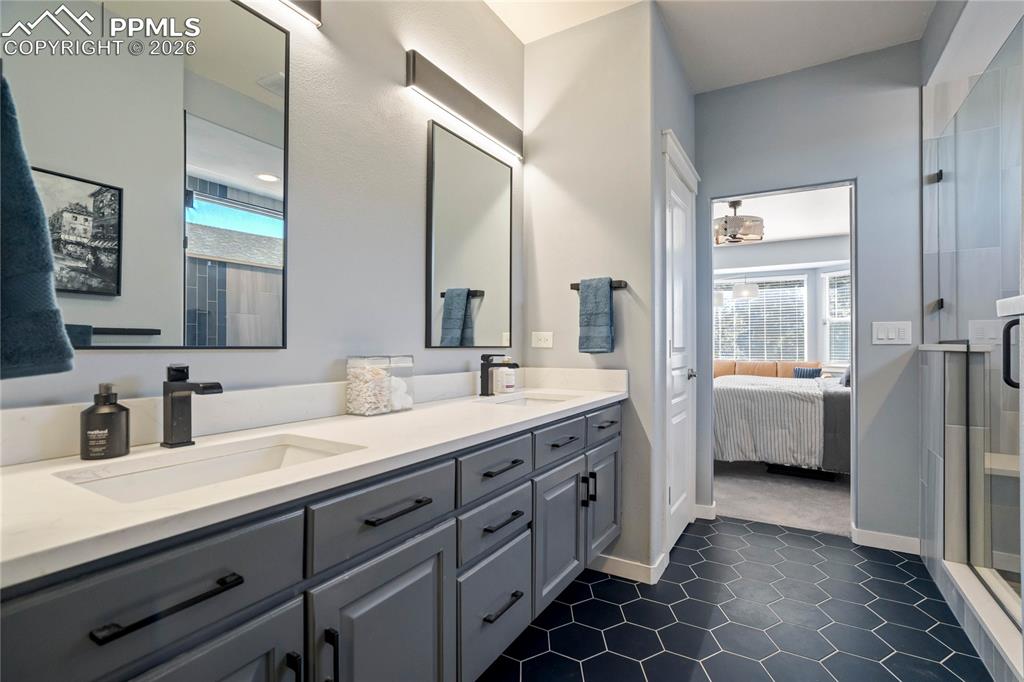 Spa-like primary bathroom with dual vanities.
