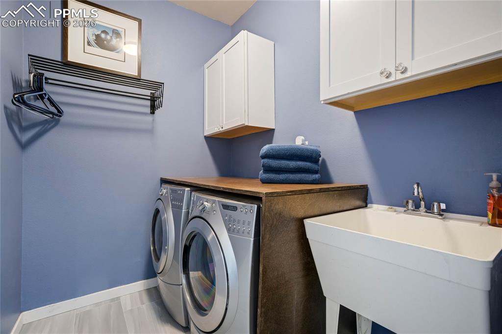 Laundry room with utility sink and storage.