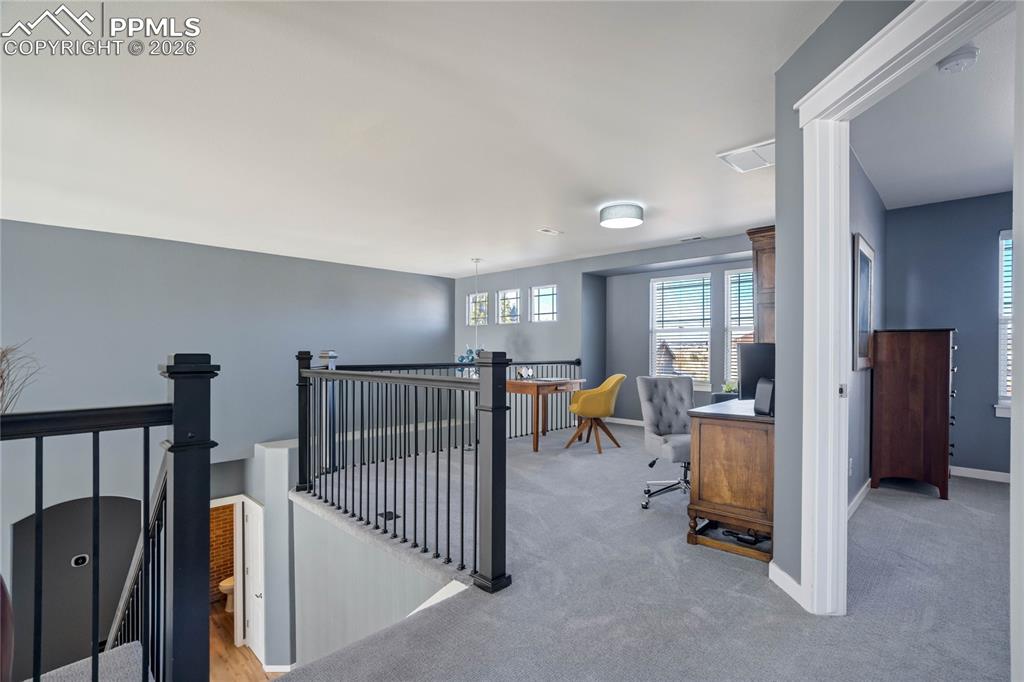 Spacious upper level loft ideal for secondary home office.