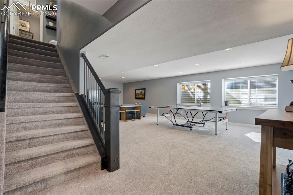 Wide staircase leads down to the finished basement.