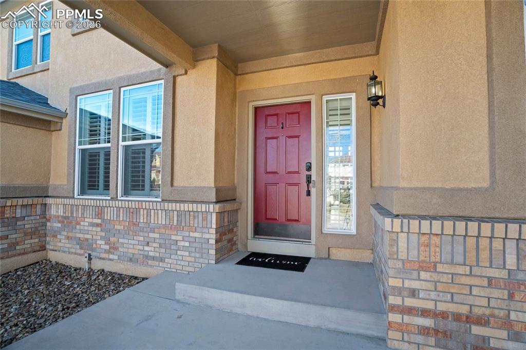 Covered front porch with welcoming red door that welcomes you home!