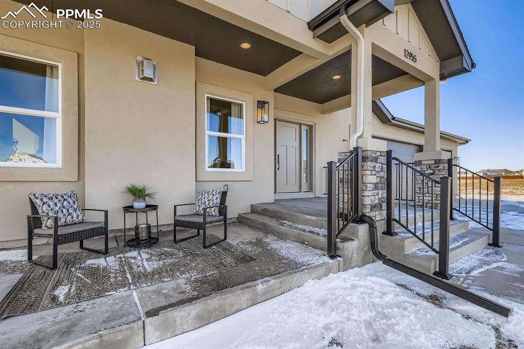 Welcoming front porch with inviting sitting area—perfect for morning coffee or relaxed outdoor living.