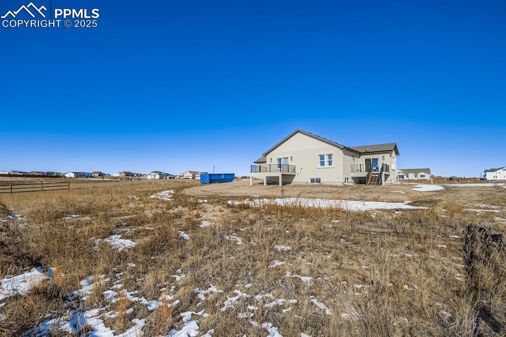Back of home showcasing yard space and outdoor possibilities.