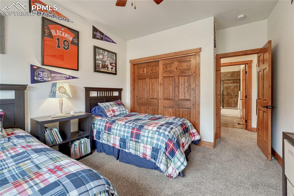 Bedroom with carpet floors, a closet, ceiling fan, and baseboards