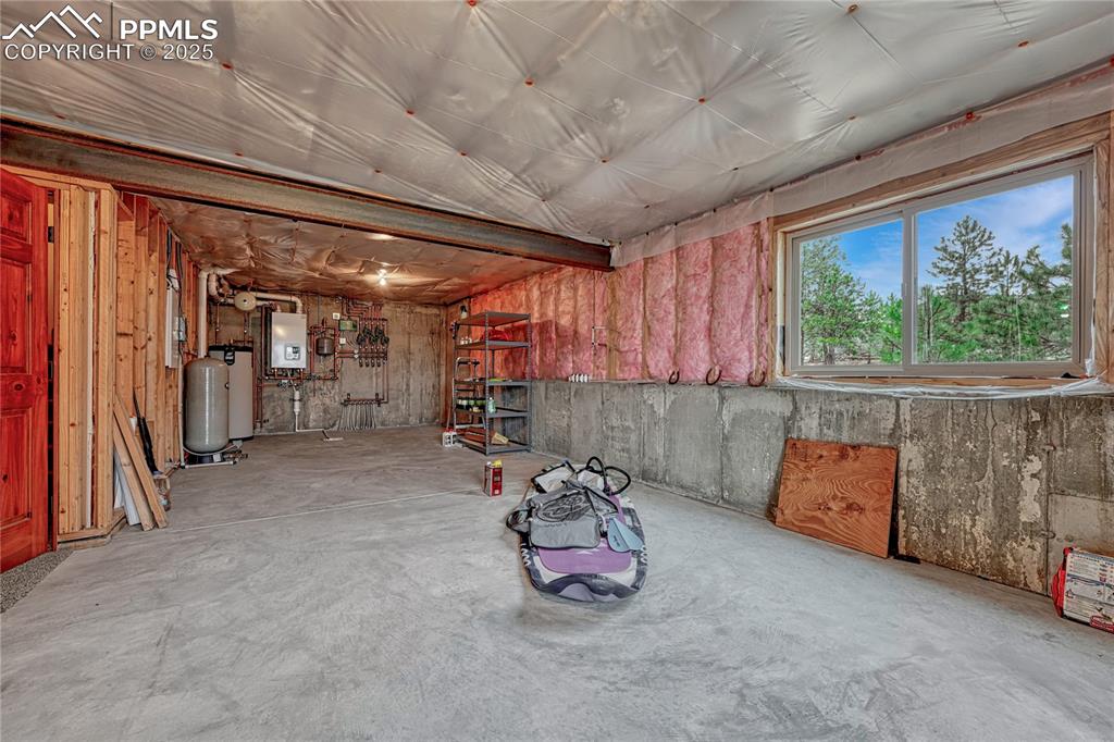 Below grade area featuring water heater