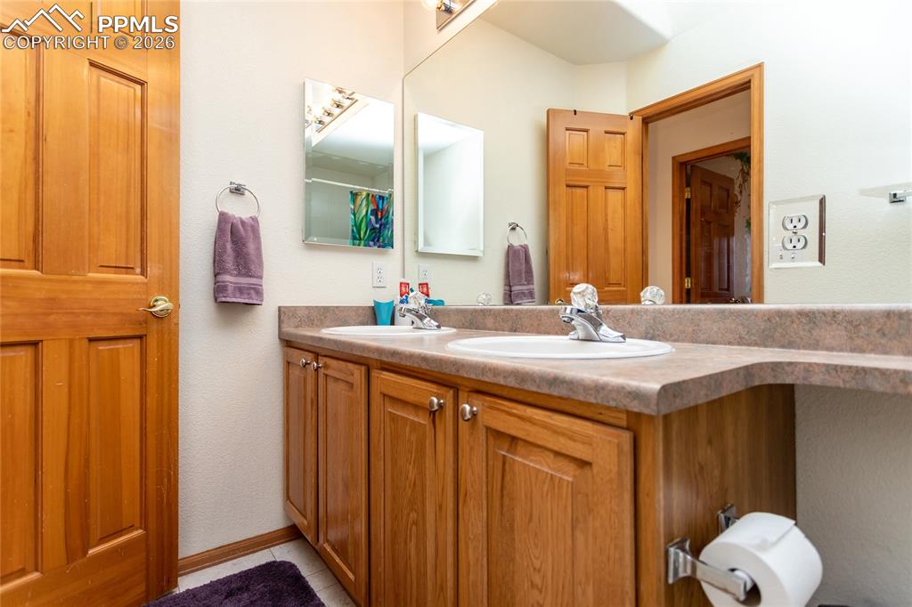Upper full bathroom with double sinks