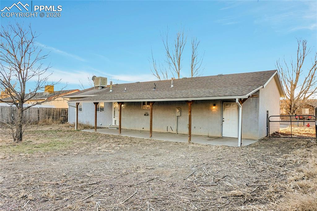 Wide side gate provides access to driveway