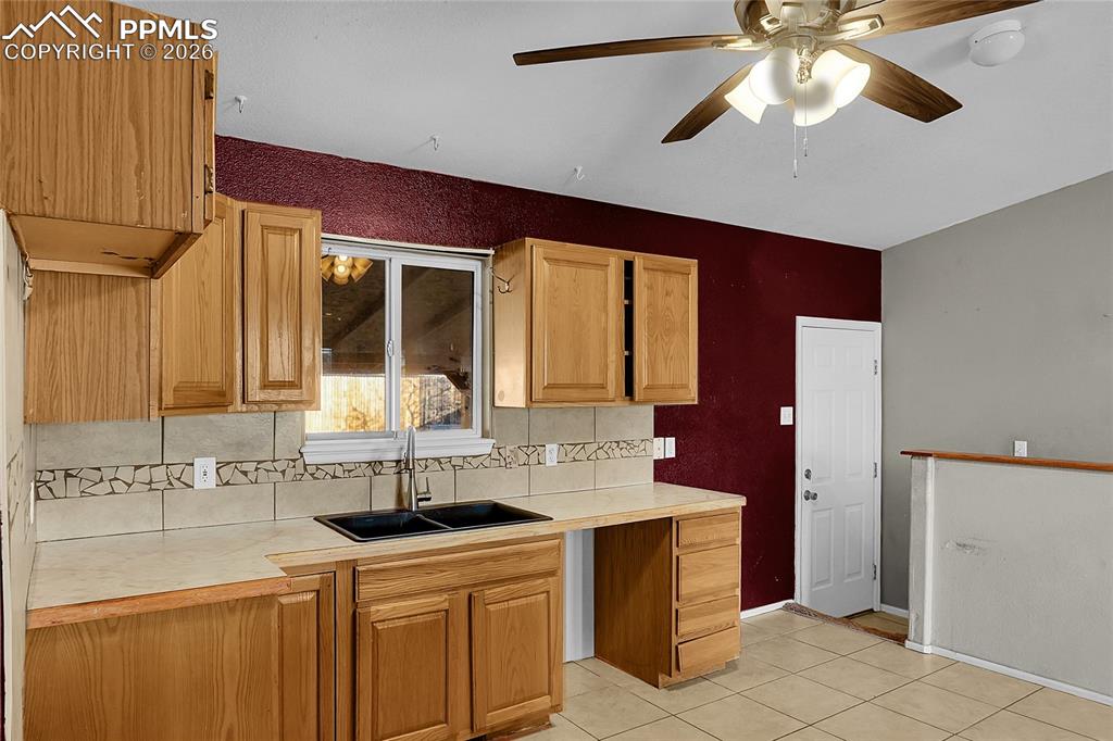 facing backyard entry and basement staircase