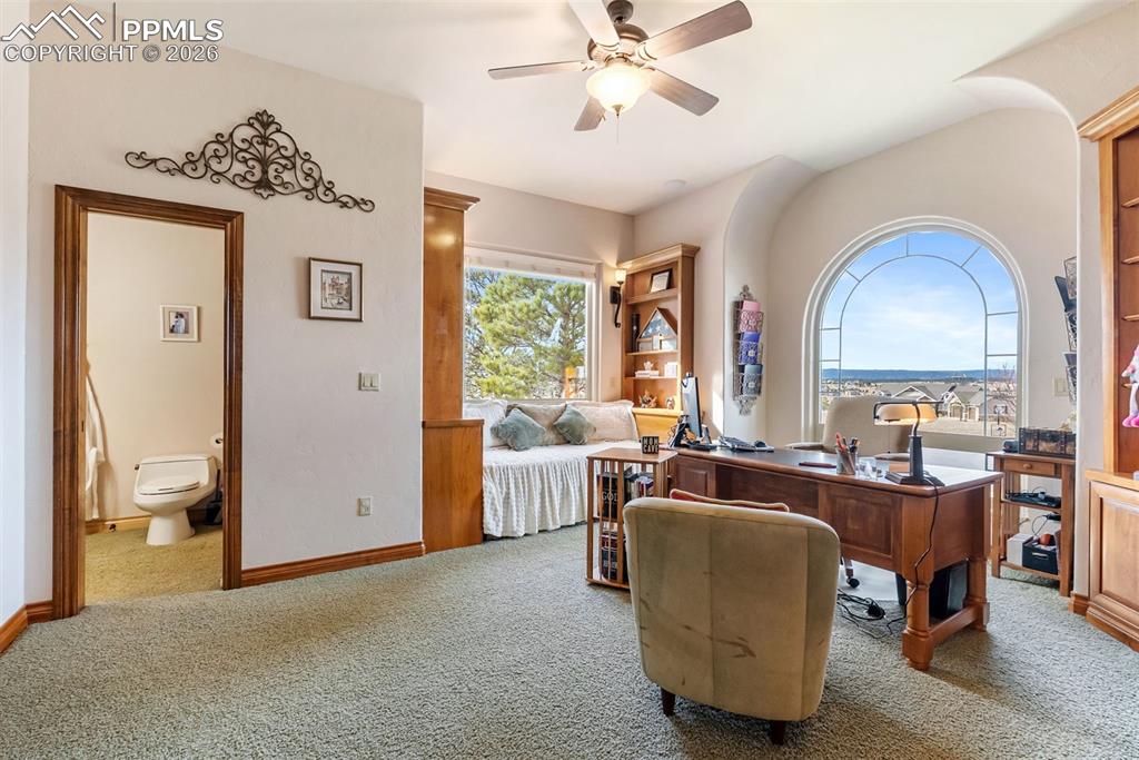 Home office with a ceiling fan and carpet floors