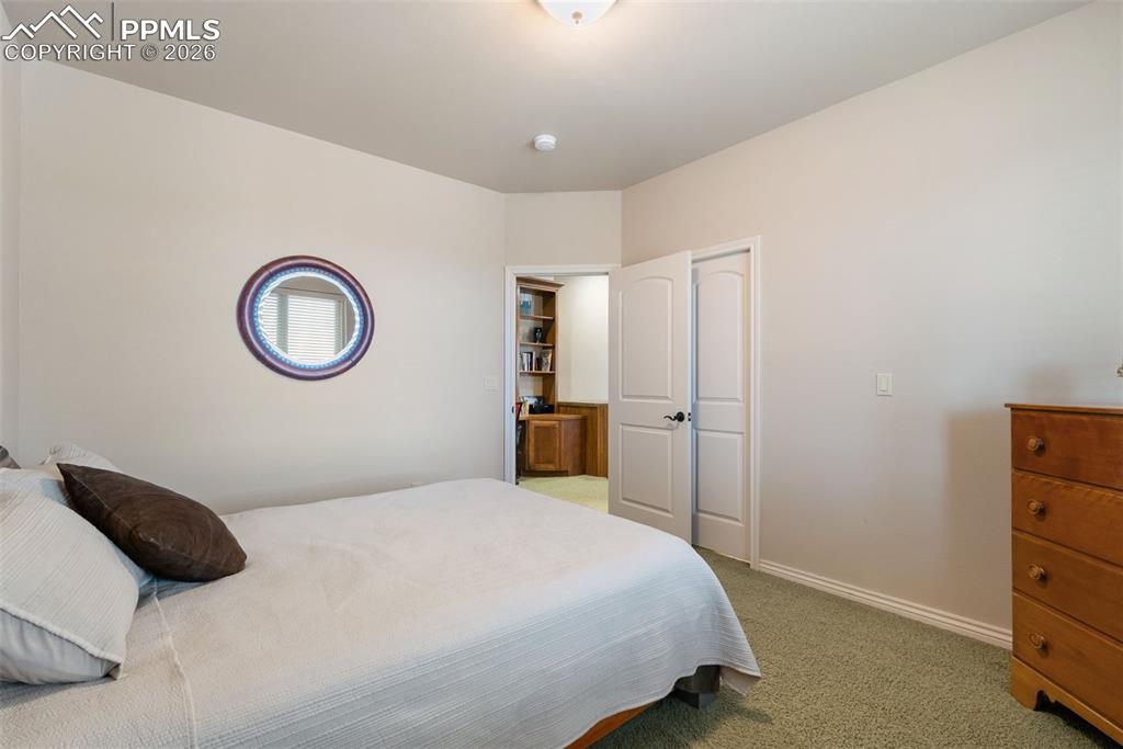 Bedroom featuring light colored carpet and baseboards