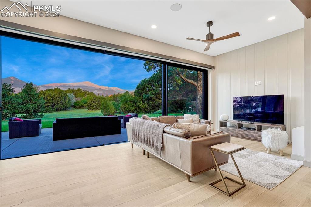 Entertainment space with high ceilings and new Lutron electric solar shades.