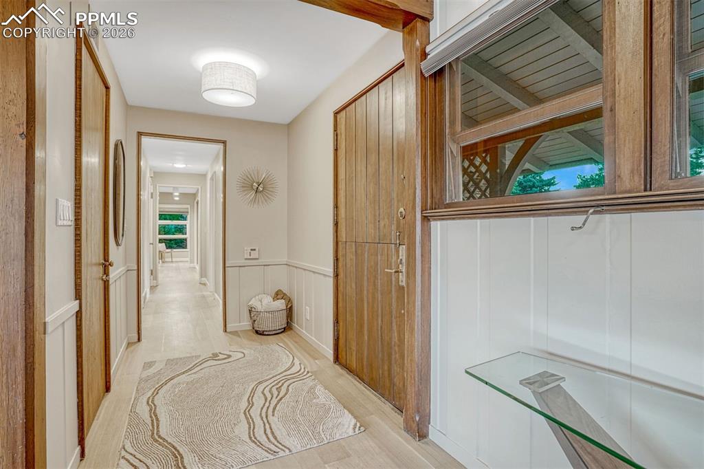 Custom Dutch entry door and gorgeous wood trim and white oak hardwood flooring.