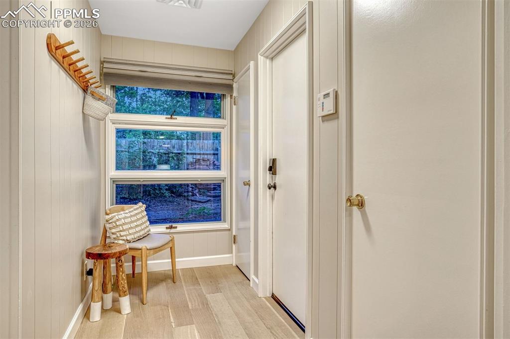 Door to Garage featuring a timber ceiling and ample storage.