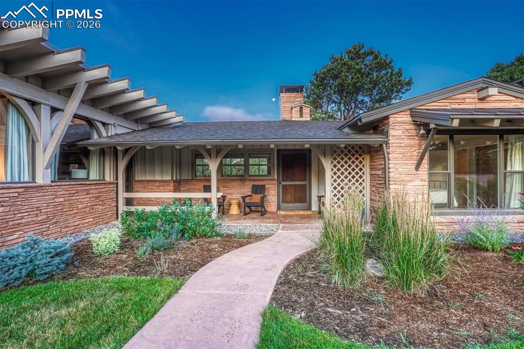 Sunlit mornings come alive on this warm and inviting covered porch, perfect for quiet moments or greeting guests.
