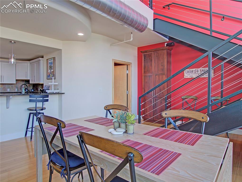 Dining area featuring light wood finished floors and recessed lighting