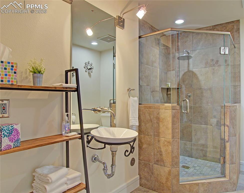 Full bathroom featuring a stall shower and recessed lighting