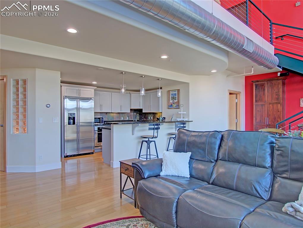 Living room featuring light wood-type flooring and recessed lighting