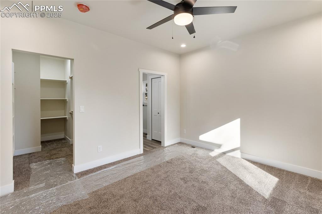 Empty room featuring recessed lighting, a ceiling fan, and carpet