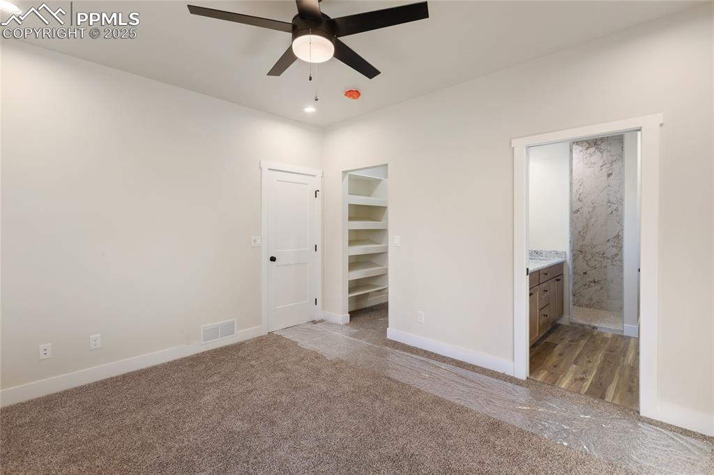 Unfurnished bedroom with recessed lighting, carpet floors, ensuite bathroom, and ceiling fan