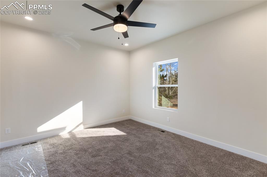 Empty room featuring carpet, recessed lighting, and ceiling fan