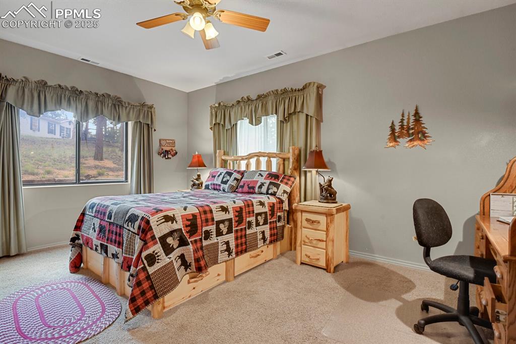 Bedroom featuring light carpet and a ceiling fan
