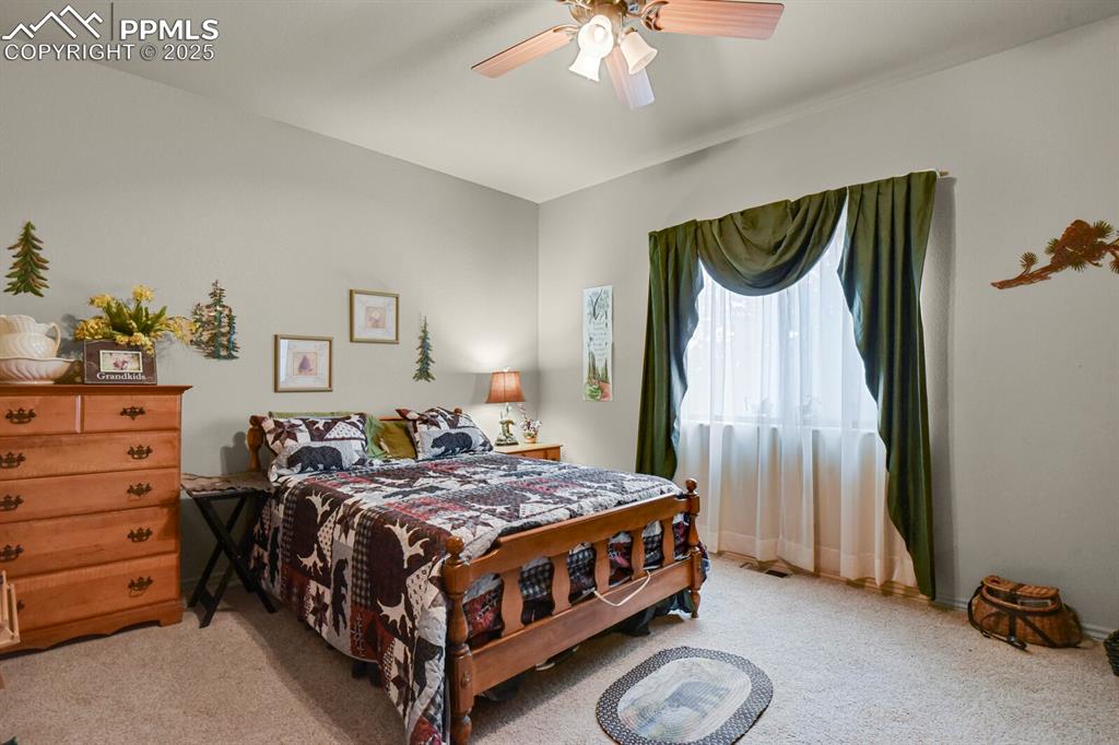 Bedroom featuring carpet and ceiling fan