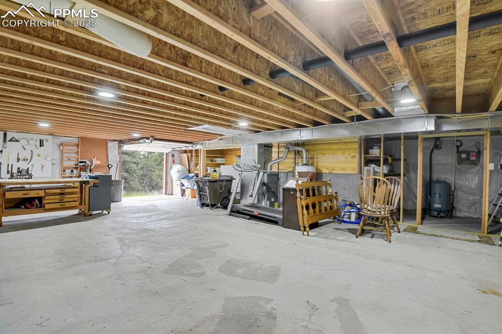 Below grade area featuring a workshop area and a water pressure tank