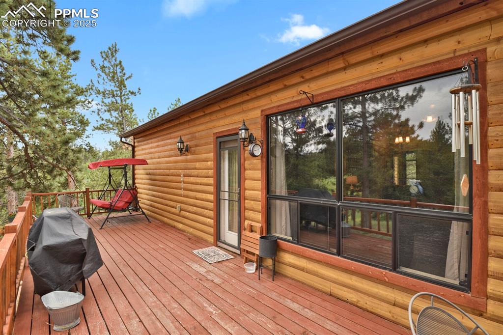 Wooden terrace featuring area for grilling