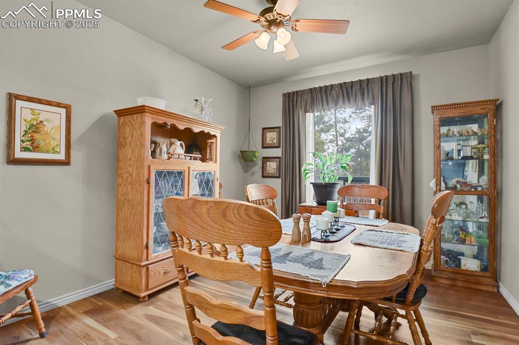 Dining space featuring a ceiling fan and light wood-style flooring
