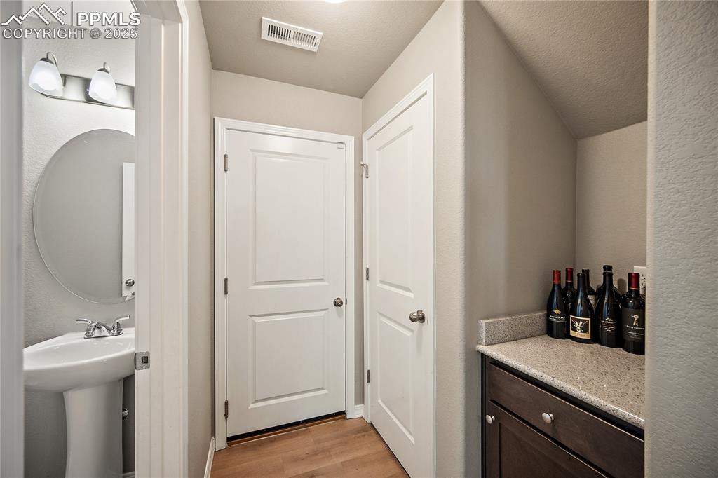 1/2 bath, coffee or wine bar space closet and door to the garage. 