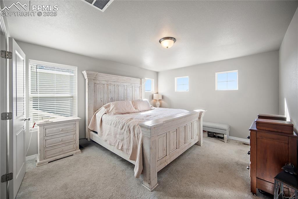 Primary suite with tons of natural light, attached bath with walk in closet.
