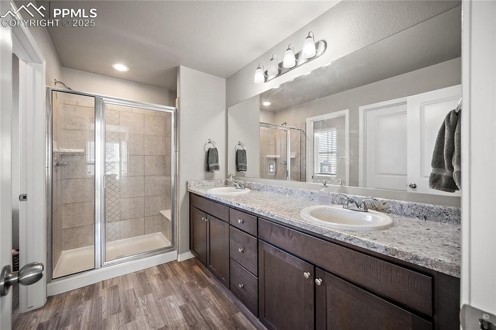 Primary bath with free standing shower and double vanity. 