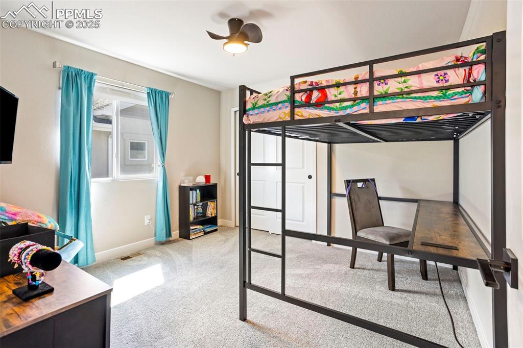 Bedroom featuring light carpet and ceiling fan