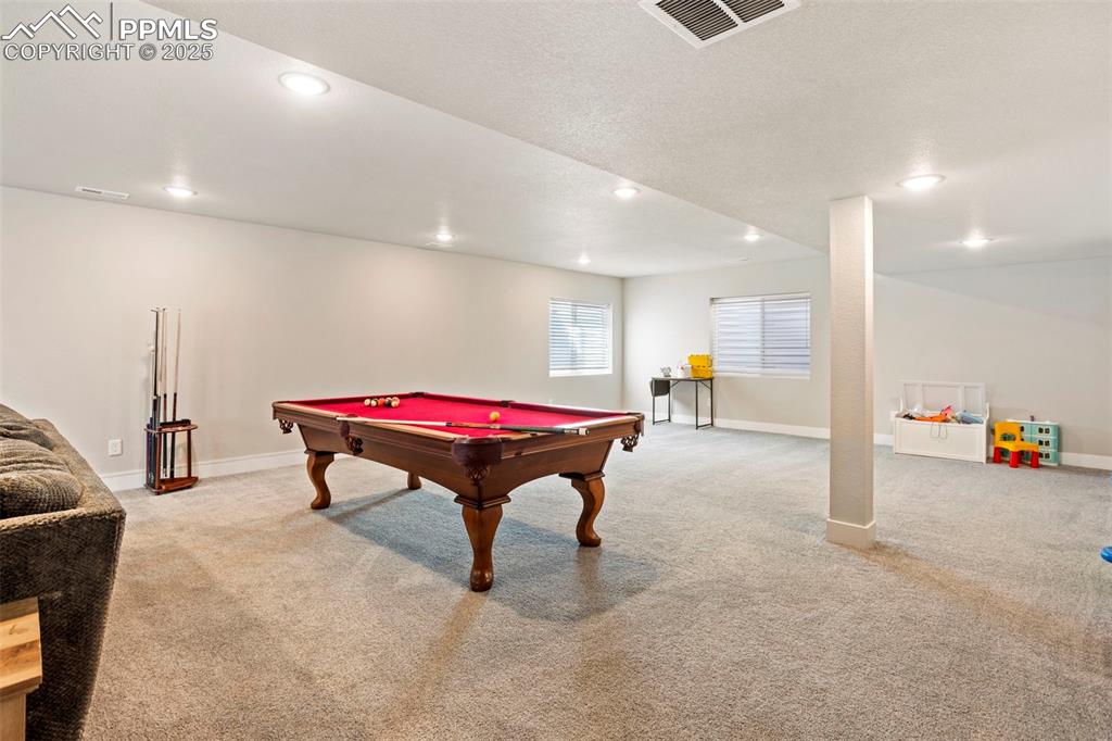 Game room featuring light carpet, recessed lighting, pool table, and a textured ceiling