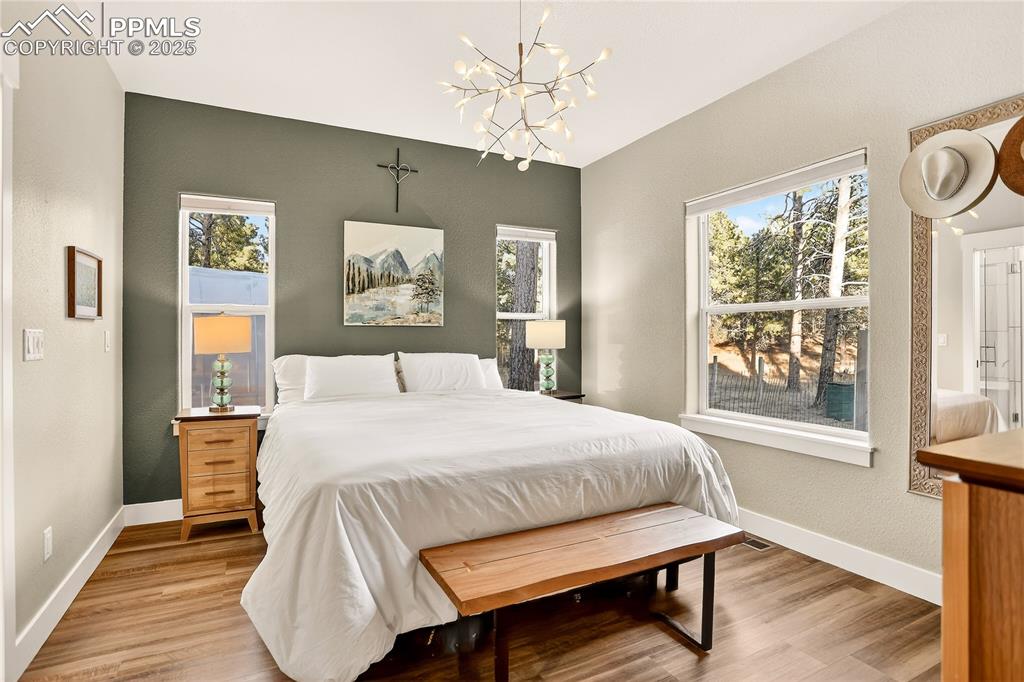 Main level primary bedroom with ensuite bathroom with modern fixtures