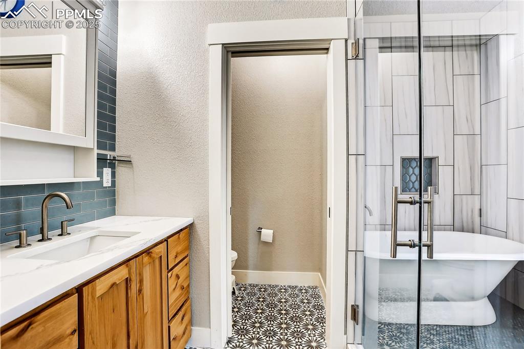 Primary bath has European style wet bath with beautiful tile and large tub