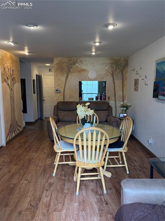 Dining area with wood finished floors and baseboards