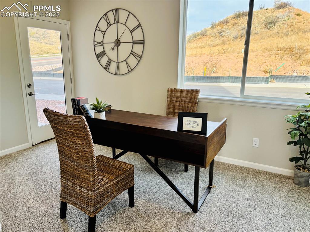 Office area with light carpet and healthy amount of natural light