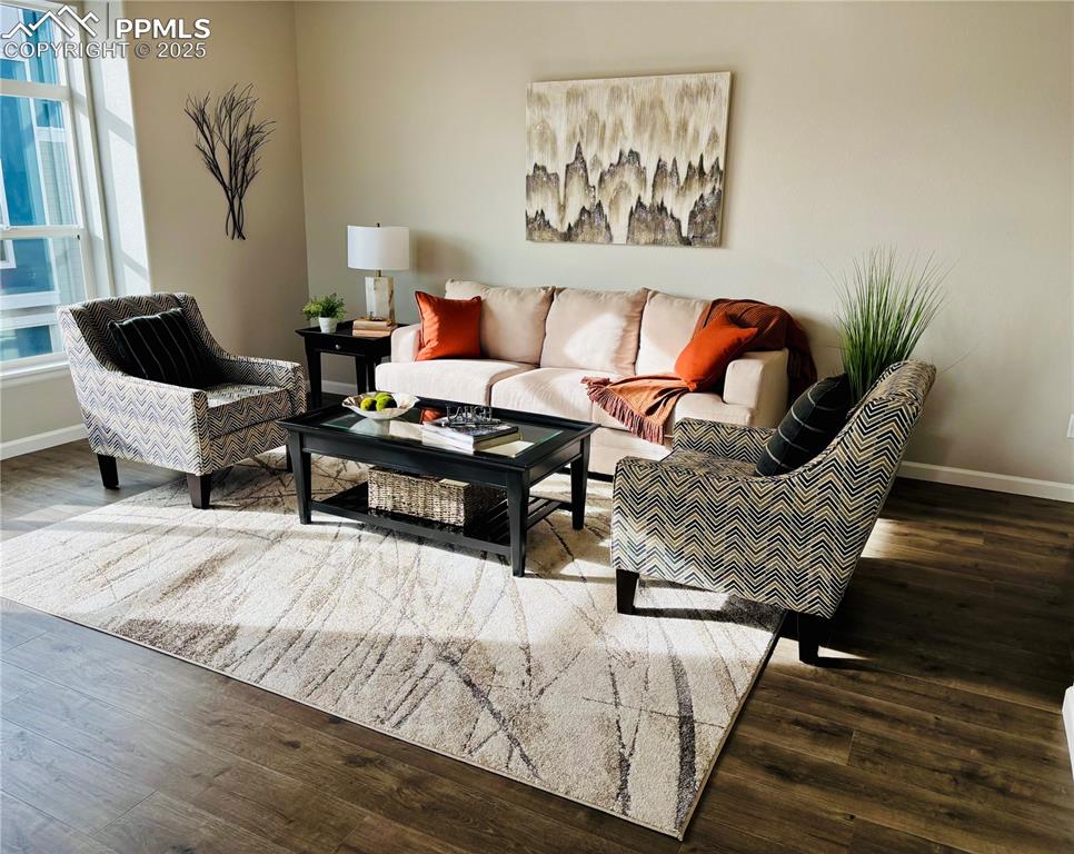 Living room with wood finished floors and baseboards
