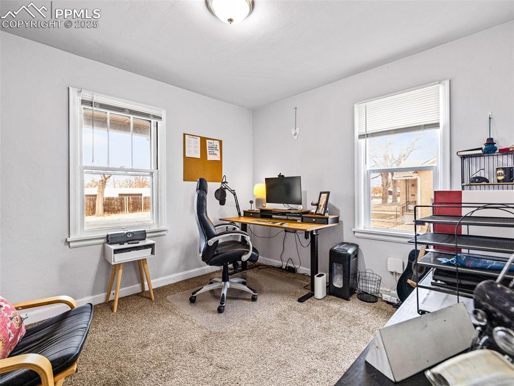 Office with light carpet and baseboards
