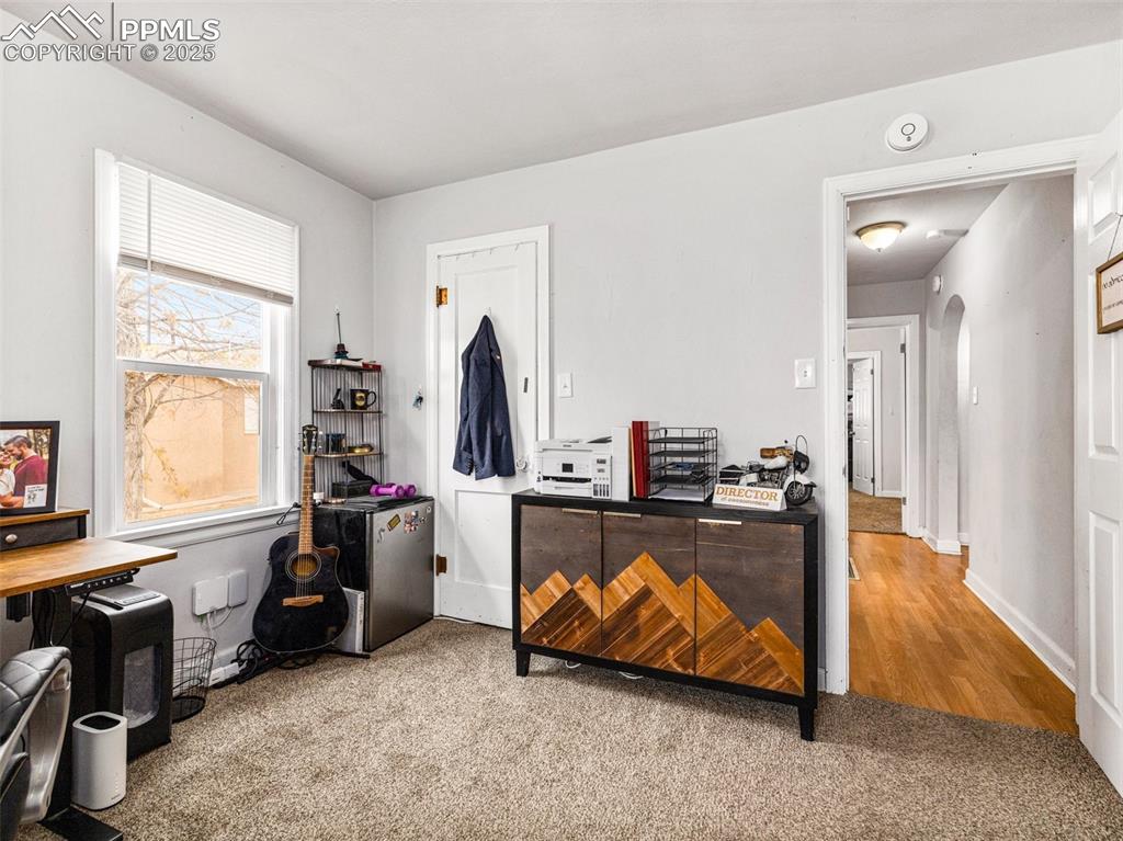 Office area with arched walkways and carpet floors