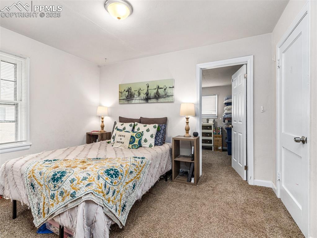Carpeted bedroom featuring baseboards