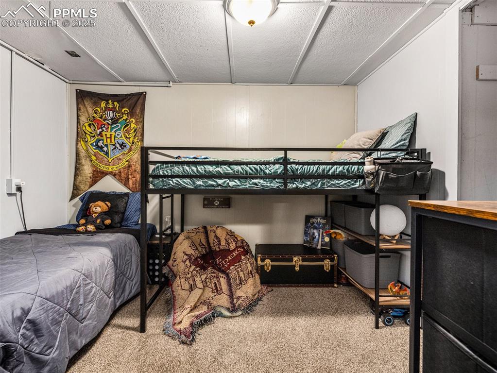 Bedroom with carpet floors and a textured ceiling