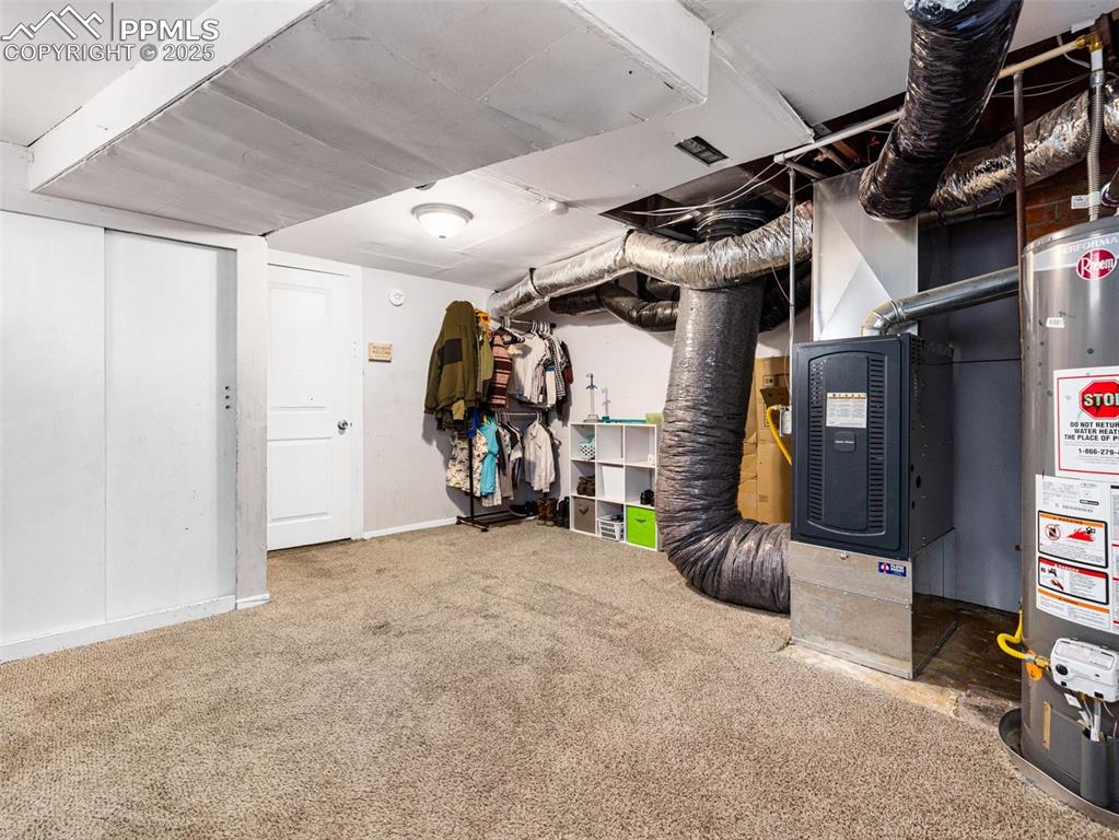 Below grade area with water heater and carpet floors
