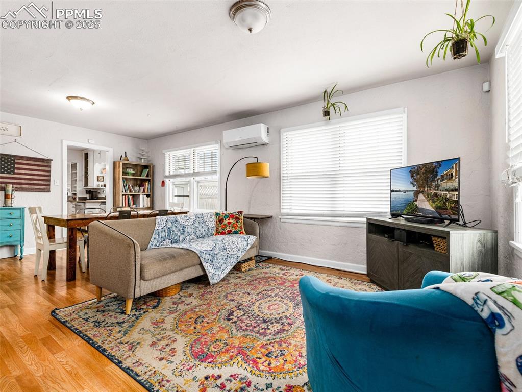 Living area with wood finished floors and baseboards