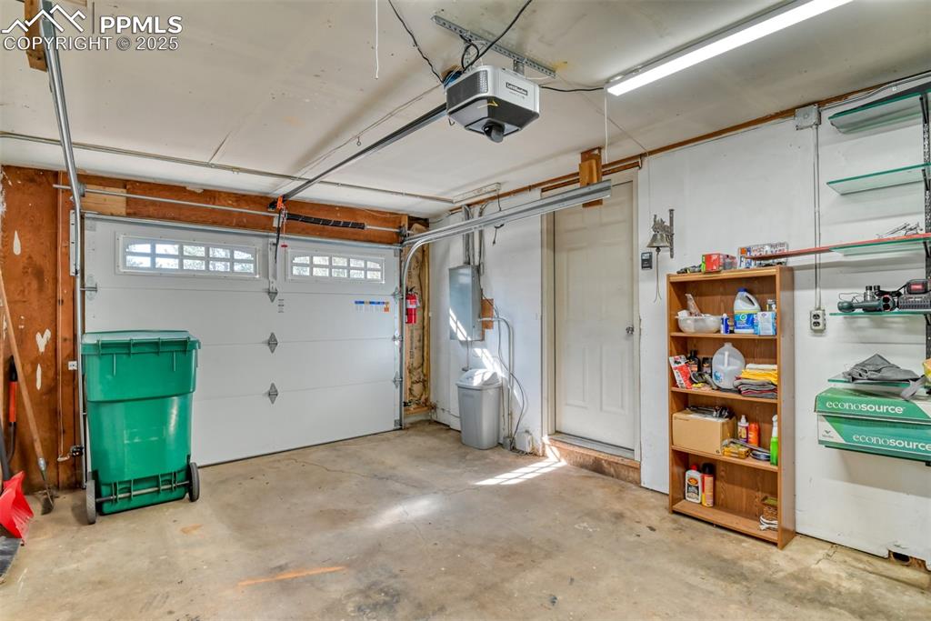Garage with a garage door opener and electric panel