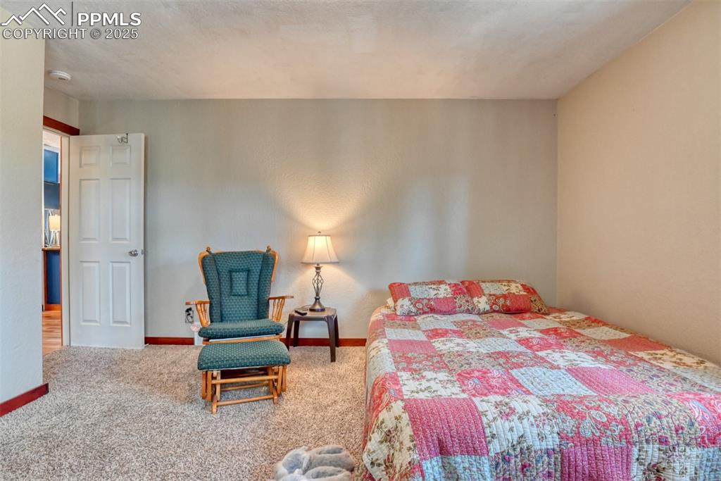 Carpeted bedroom with baseboards